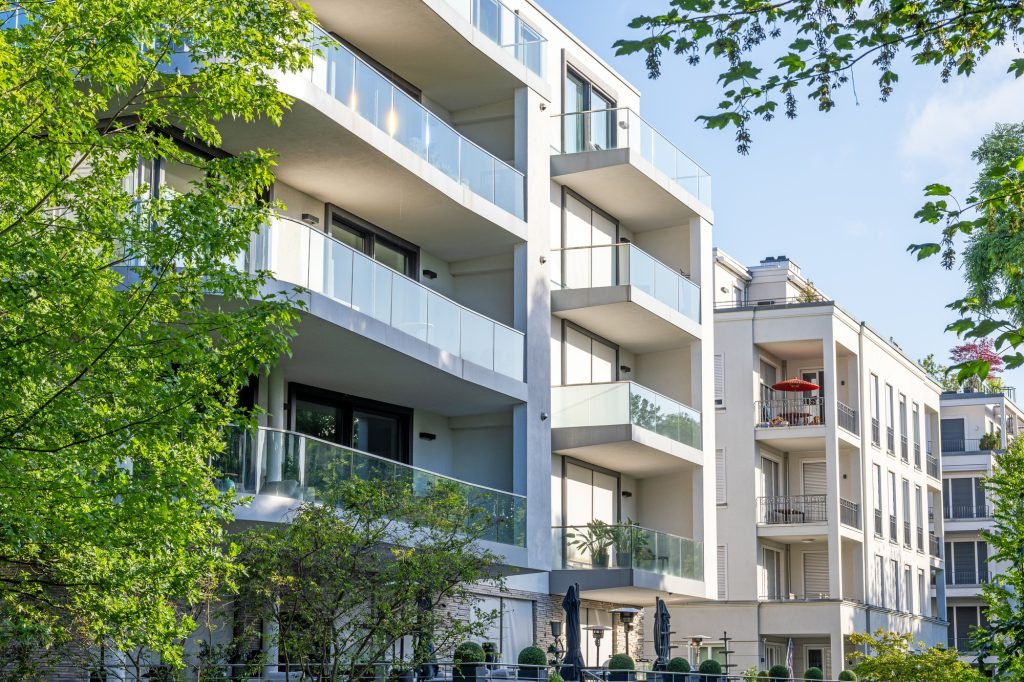 Modern apartment buildings surrounded by greens