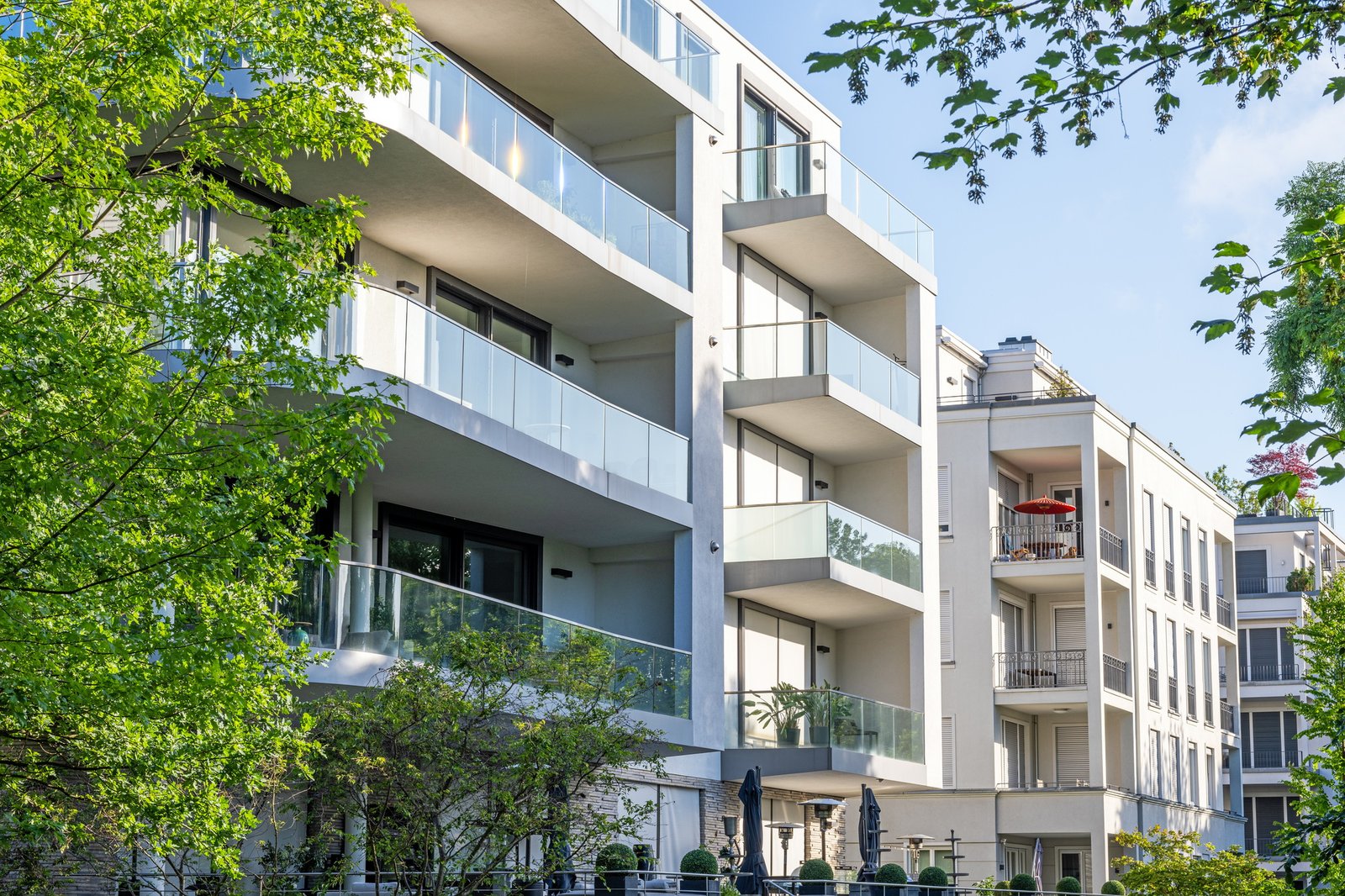 Modern apartment buildings surrounded by greens